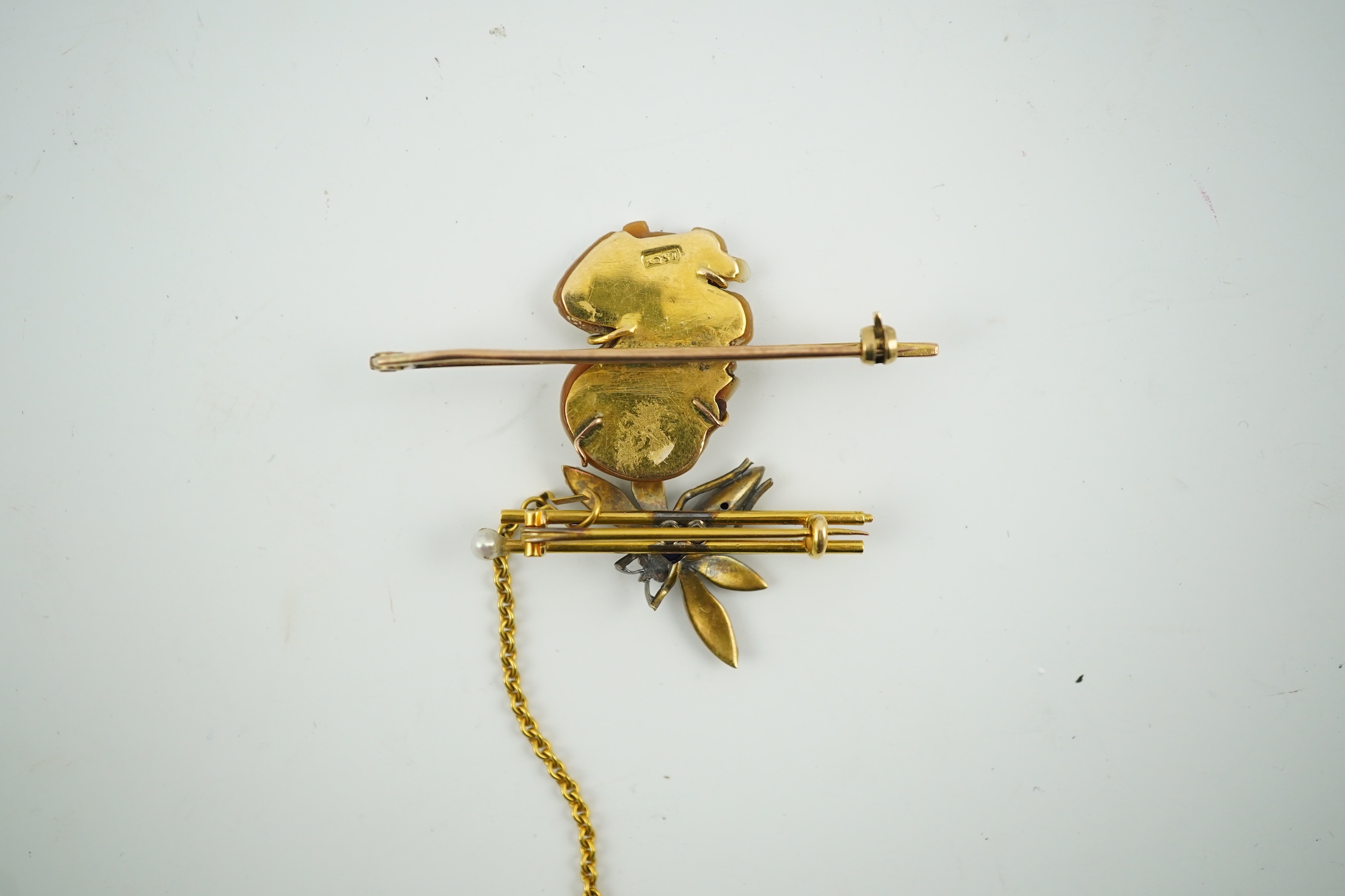 An Edwardian 15ct mounted cameo shell bar brooch, 49mm, together with a yellow metal, sapphire and split pearl cluster set dragonfly bar brooch, 11 grams. Condition - fair